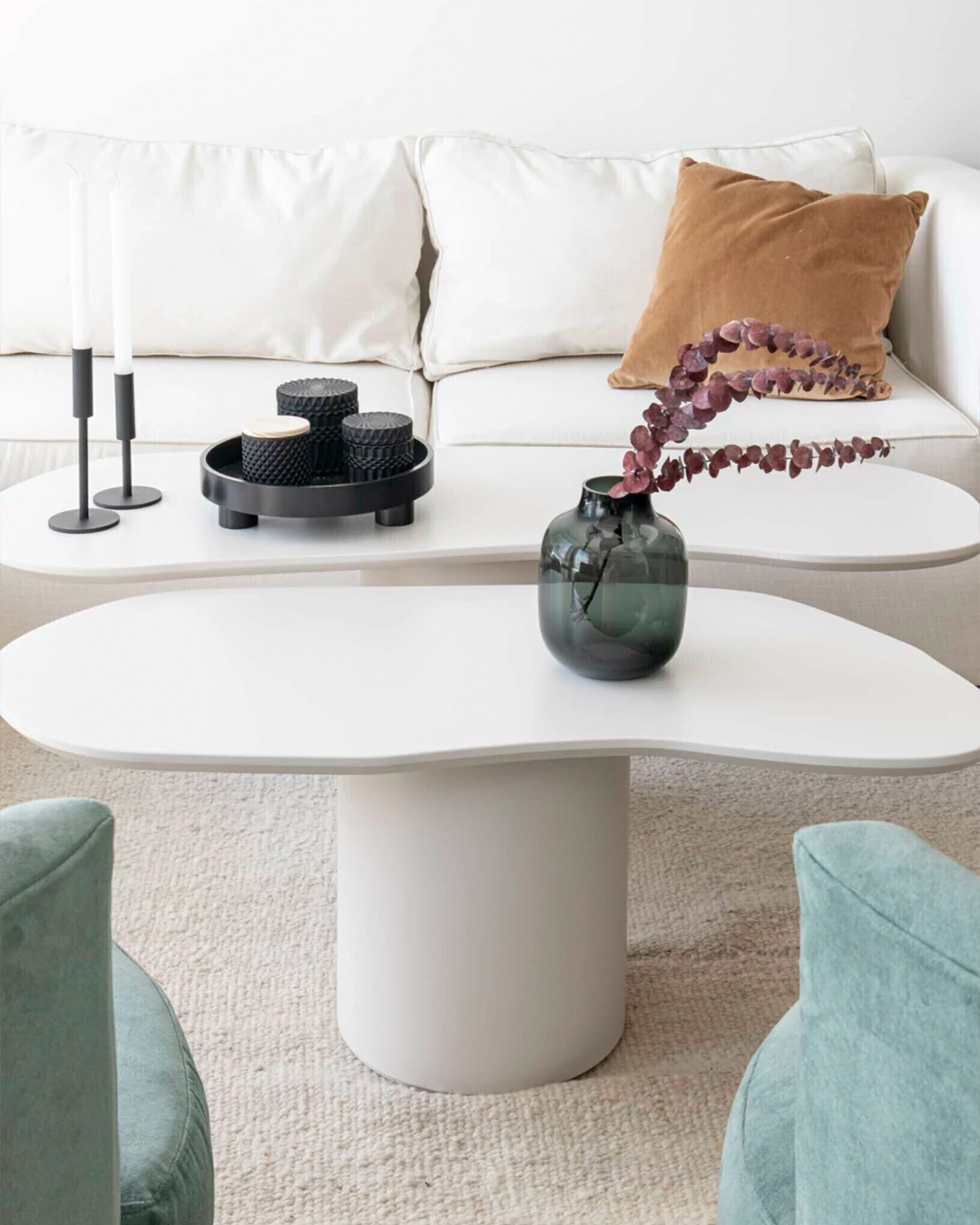 Solid Natural wool rug styled under white coffee tables in modern living room