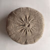 Round cushion in Beige and Natural White, shown from the back.