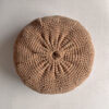 Round cushion in Camel and Natural White, shown from the back.