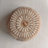 Round cushion in Camel and Natural White with comb-pattern design, shown from the front.