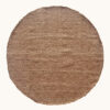 Full view of round wool rug in wood tone (brown), laid on a neutral background.