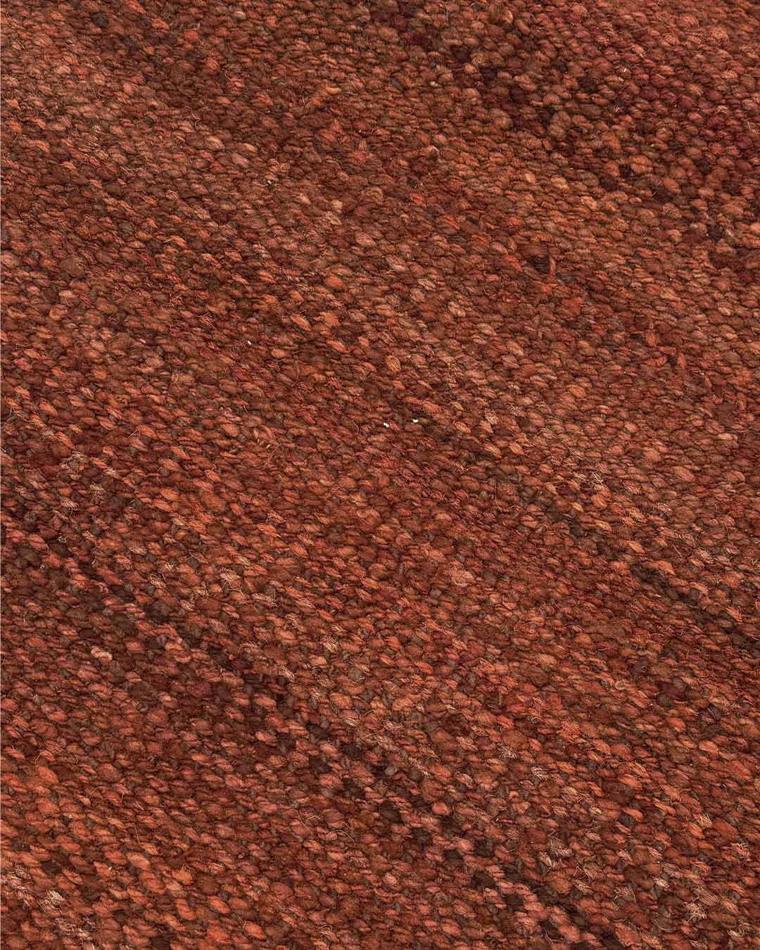 Macro detail of the hand-dyed burgundy wool fibers showing natural tonal variation