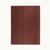 Flat lay of a handwoven wool rug in burgundy, featuring a subtle tonal variation in its texture.