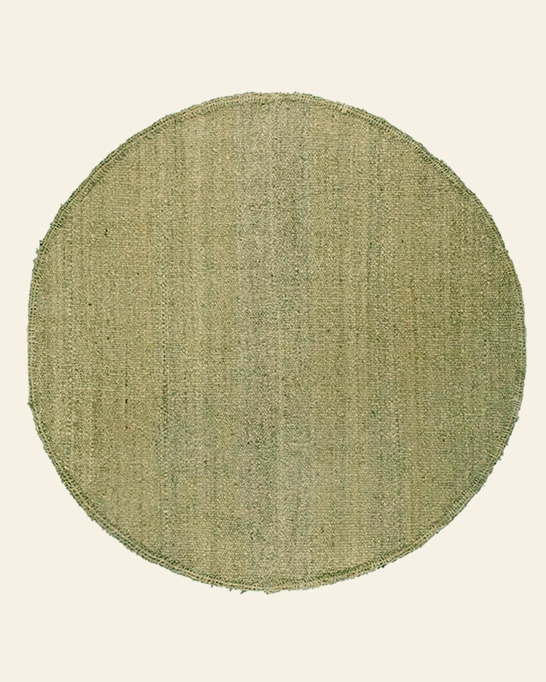 Overhead view of a round rug in yerba green wool, showing its natural color and soft texture.