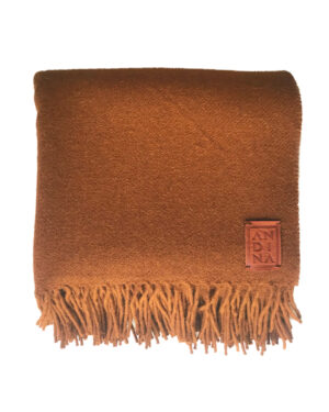 Tobacco fringed llama frizada throw blanket by Andina Decor on a white background.