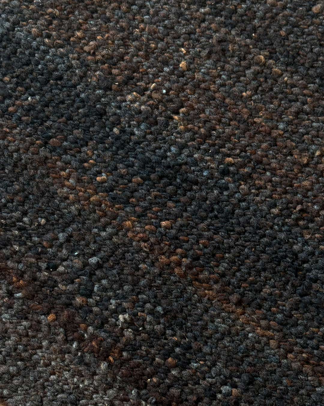Close-up texture of solid coffee handwoven wool rug