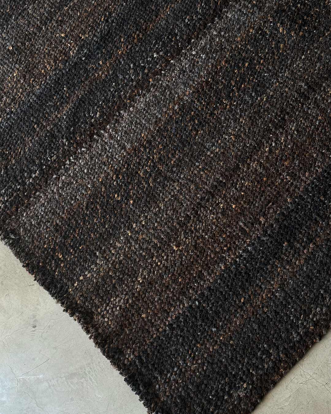 Solid coffee wool rug with natural tonal variations
