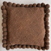 Chocolate Brown square cushion with handmade pom poms, shown from the front.