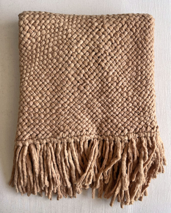 Camel handwoven wool throw with fringes, neatly folded to show texture and weave.