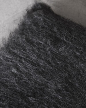 Macro detail of the Black llama cushion’s brushed deep pile fiber