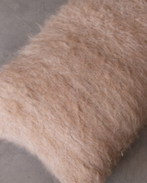 Side view of the Oat llama lumbar cushion’s edge, showing the depth of the brushed pile